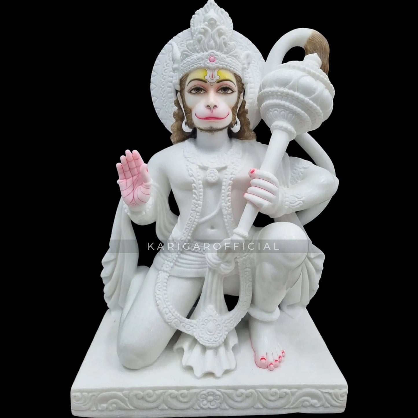 Close-up of the White Marble Hanuman Statue showing intricate carvings and hand-painted details, with Hanuman holding a gada and his tail elegantly curled behind him